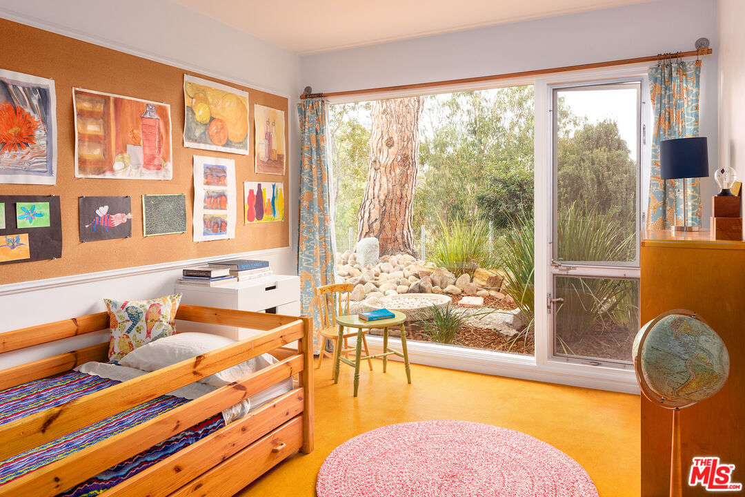 721 Rochedale Way Los Angeles, CA 90049 - Photo 13 of 25 a living room with patio furniture and floor to ceiling windows