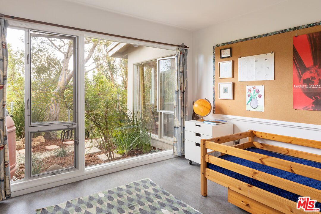 721 Rochedale Way Los Angeles, CA 90049 - Photo 14 of 25 a view of a room that has a bed and wooden floor