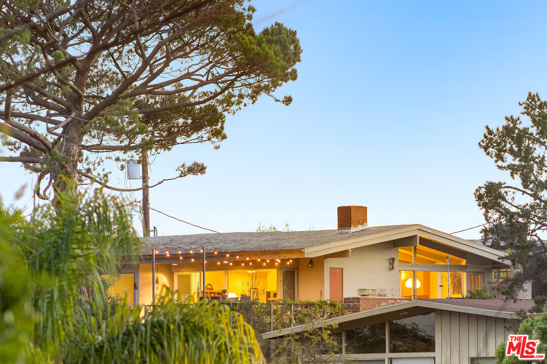 721 Rochedale Way Los Angeles, CA 90049 - Photo 24 of 25 a view of a big house with a big yard and large trees