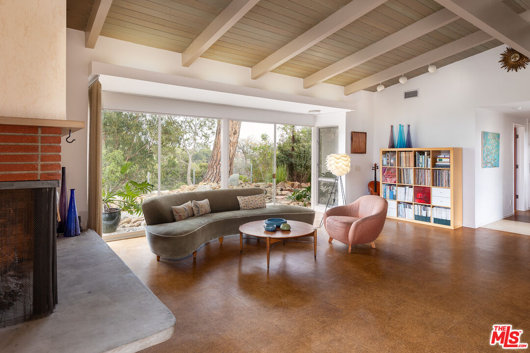 721 Rochedale Way Los Angeles, CA 90049 - Photo 4 of 25 a living room with furniture and a fireplace