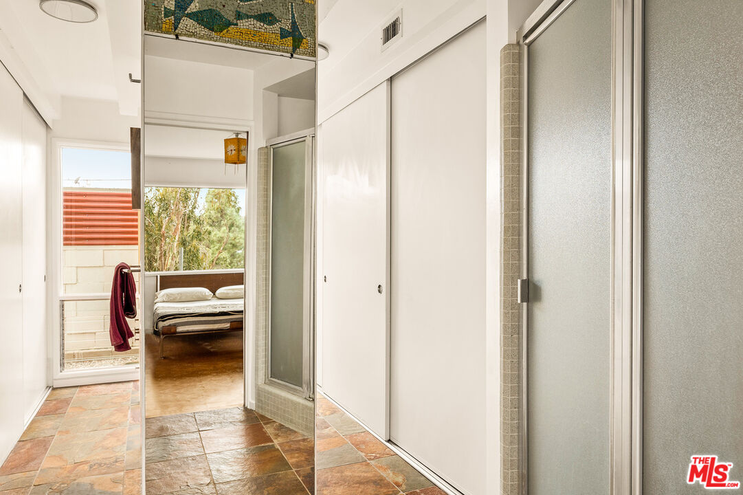 721 Rochedale Way Los Angeles, CA 90049 - Photo 10 of 25 a view of a bedroom with furniture and a window