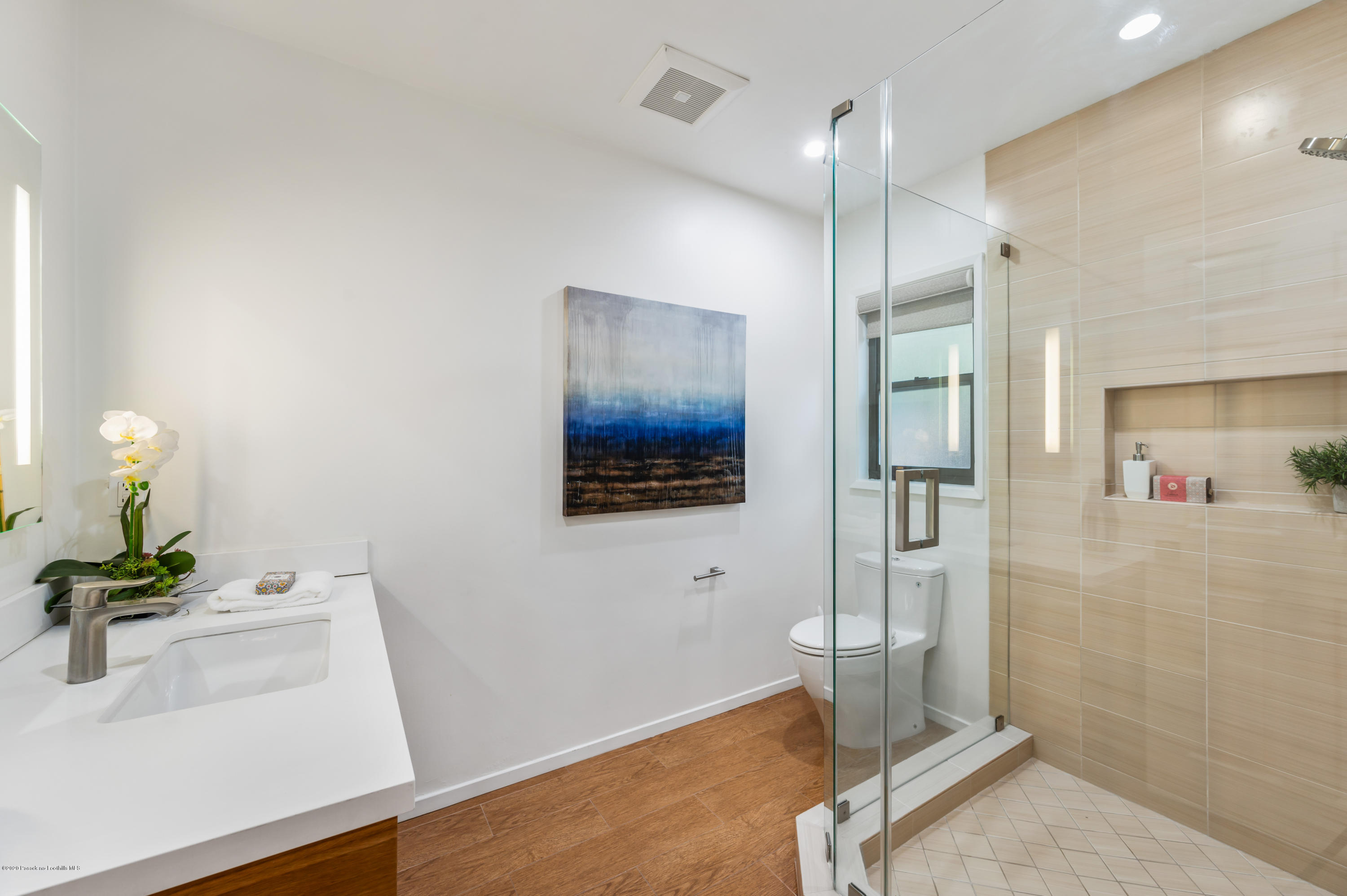 1225 Mesa Road San Marino, CA 91108 - Photo 25 of 48 a bathroom with a sink a light fixture and a glass door shower