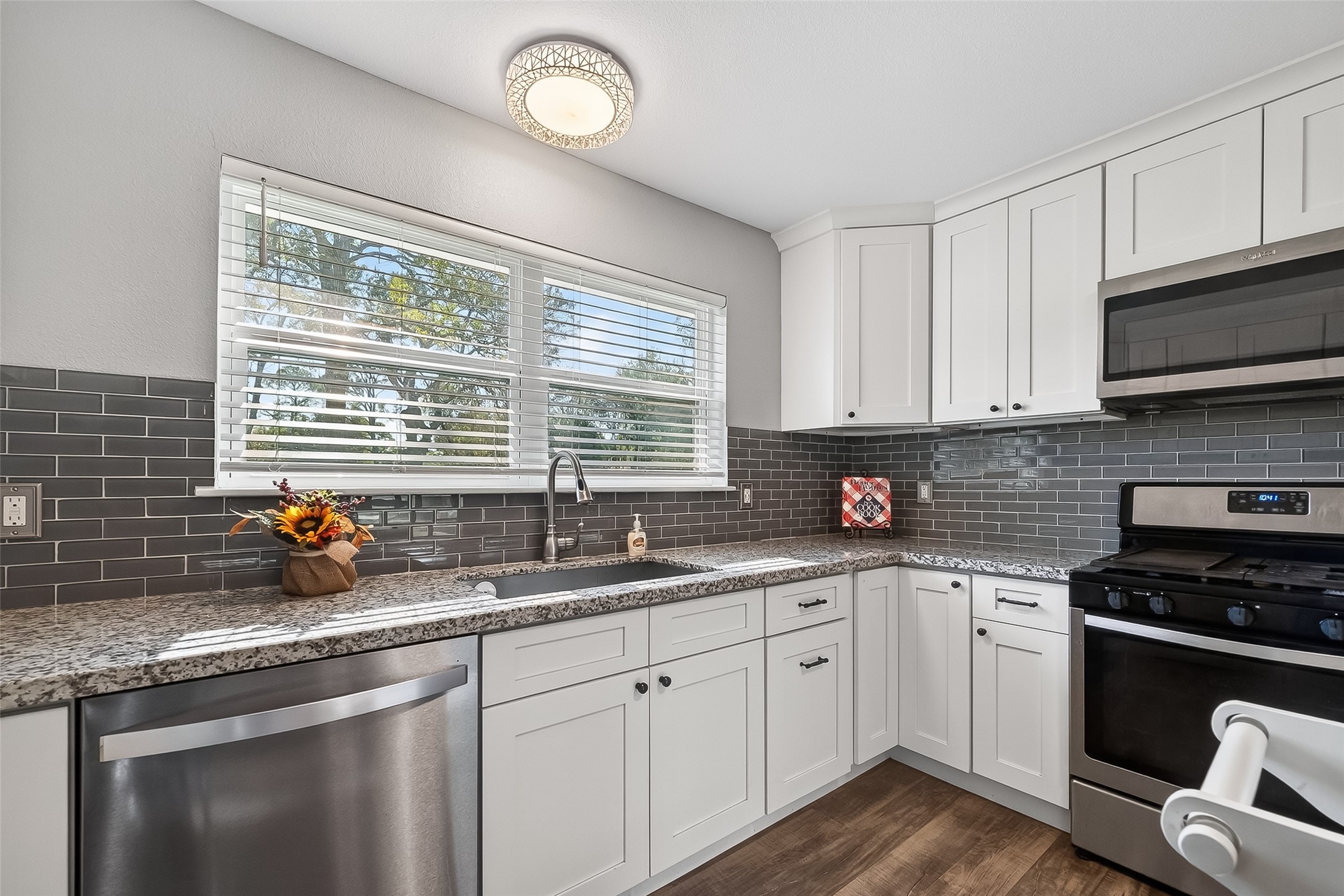12430 Eiker Road Pearland, TX 77581 - Photo 12 of 41 a kitchen with stainless steel appliances a sink a stove and cabinets