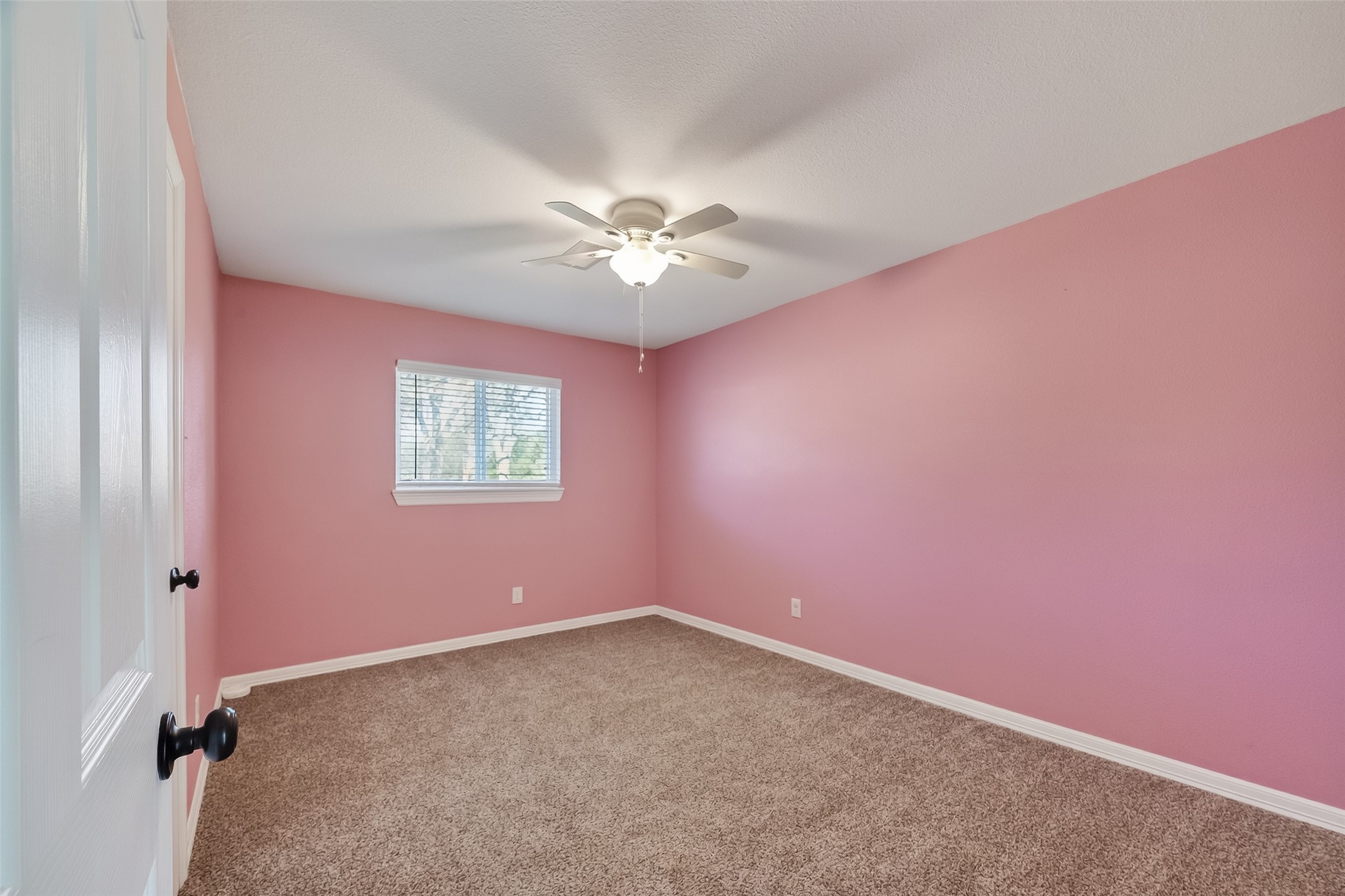 12430 Eiker Road Pearland, TX 77581 - Photo 25 of 41 an empty room with a chandelier fan and a window