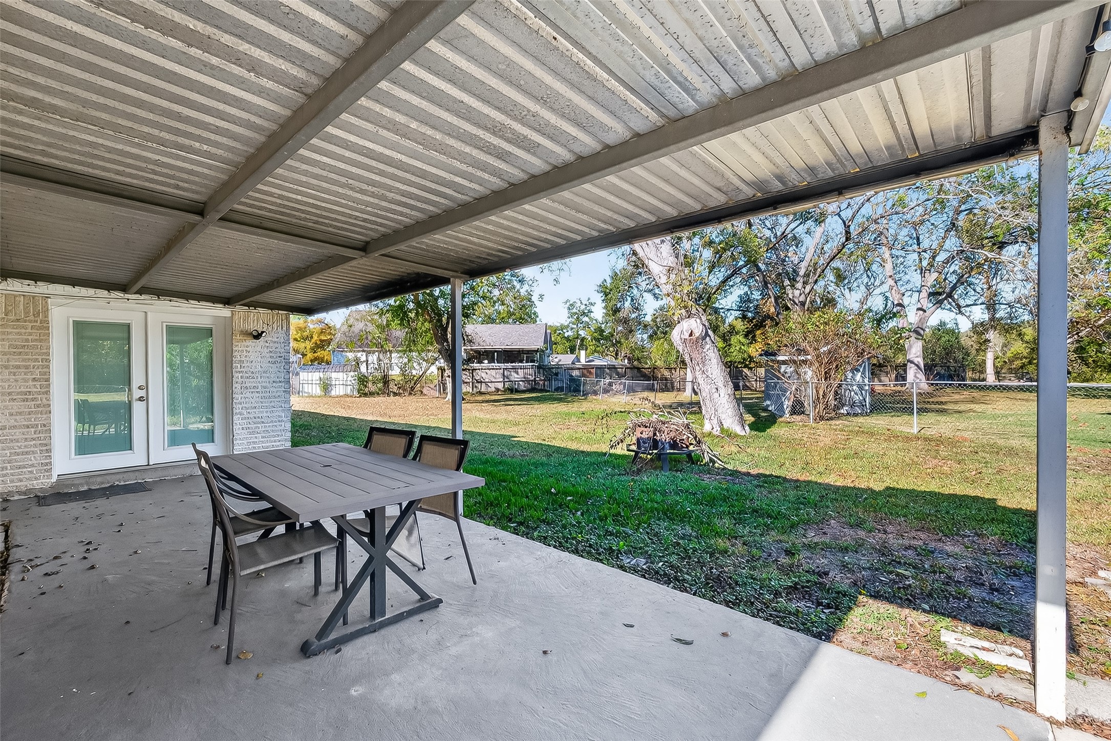 12430 Eiker Road Pearland, TX 77581 - Photo 26 of 41 a view of a patio with a table chairs and a backyard
