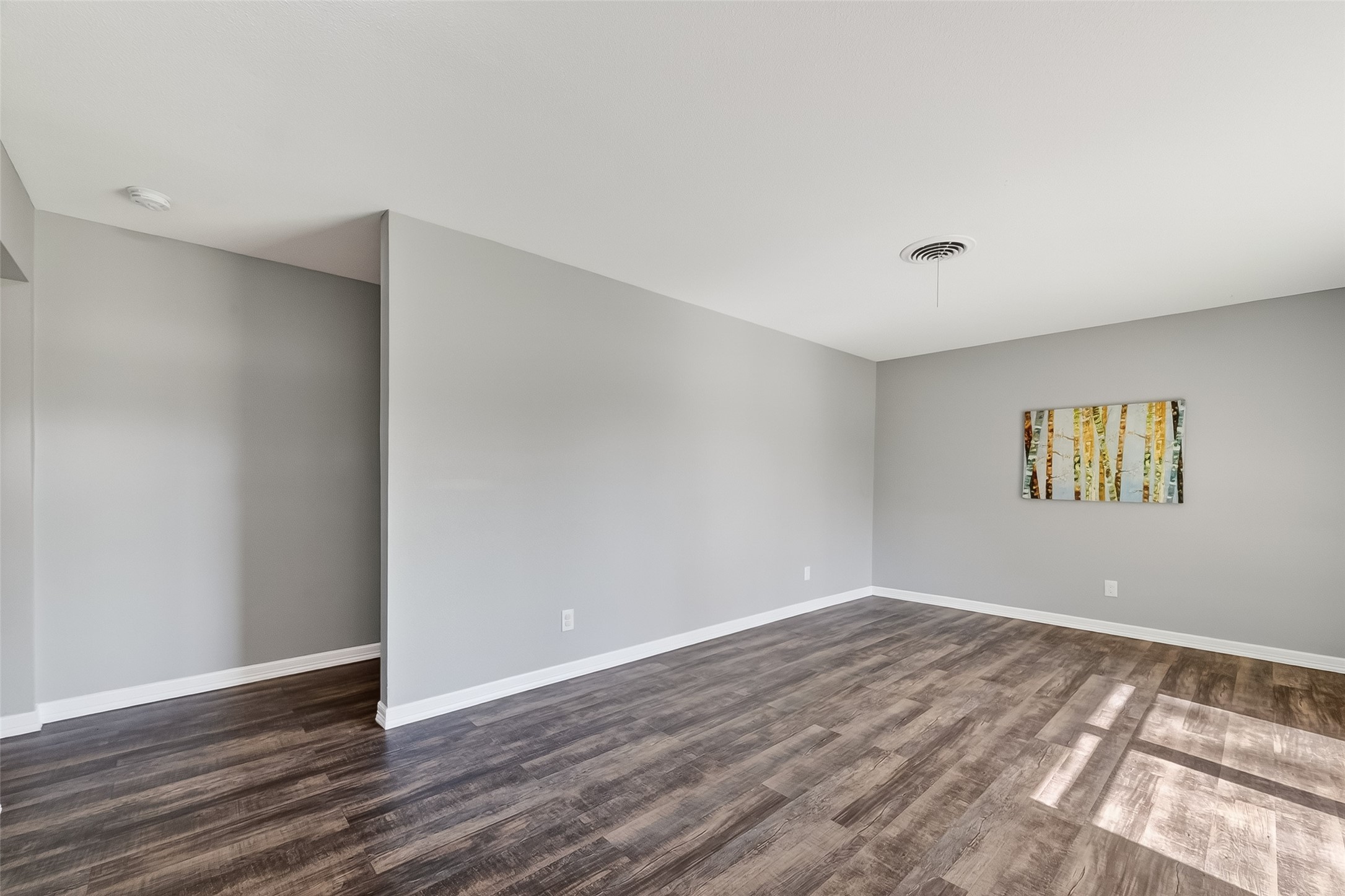 12430 Eiker Road Pearland, TX 77581 - Photo 6 of 41 a view of an empty room with wooden floor and a window