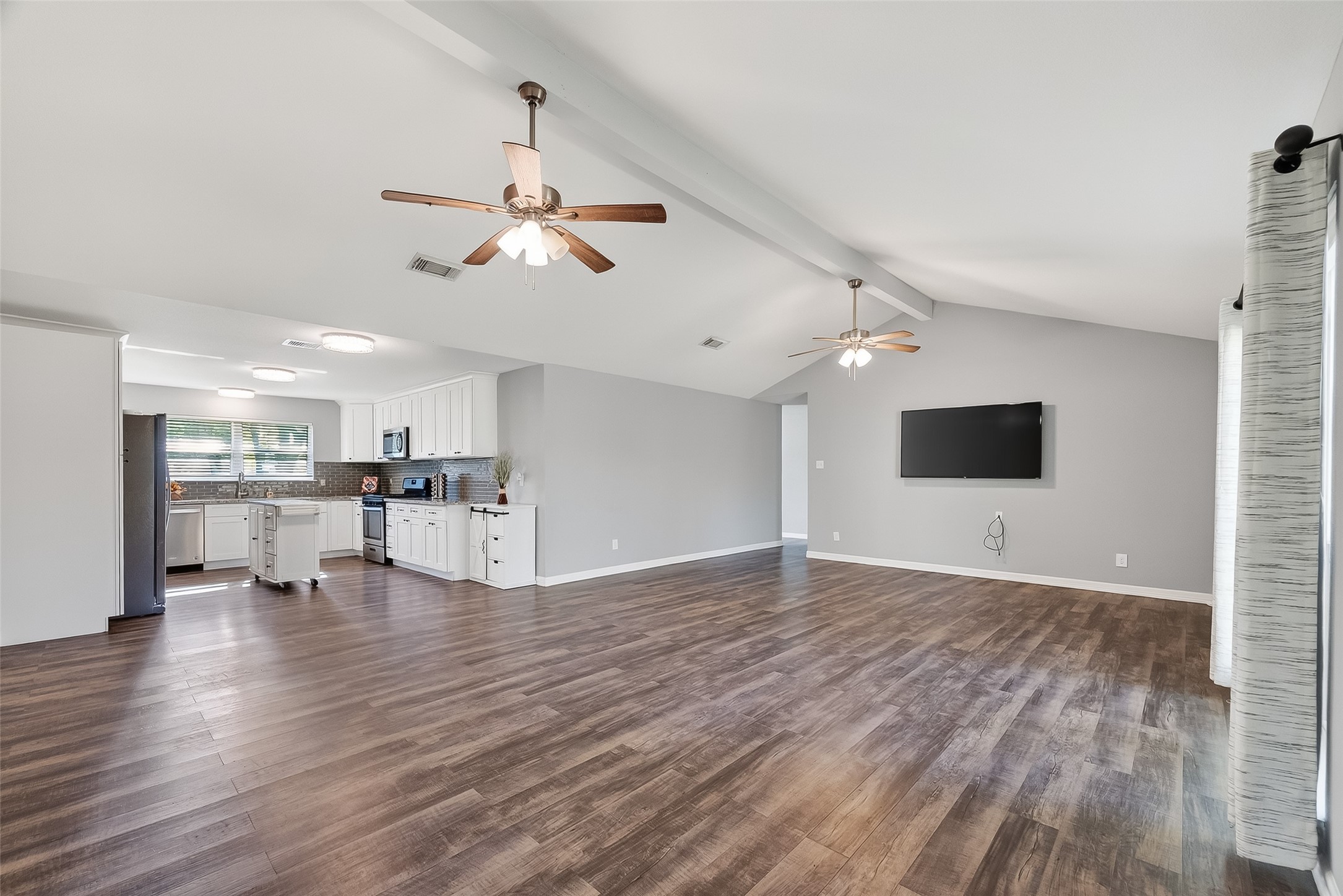 12430 Eiker Road Pearland, TX 77581 - Photo 9 of 41 a view of empty room with wooden floor and ceiling fan
