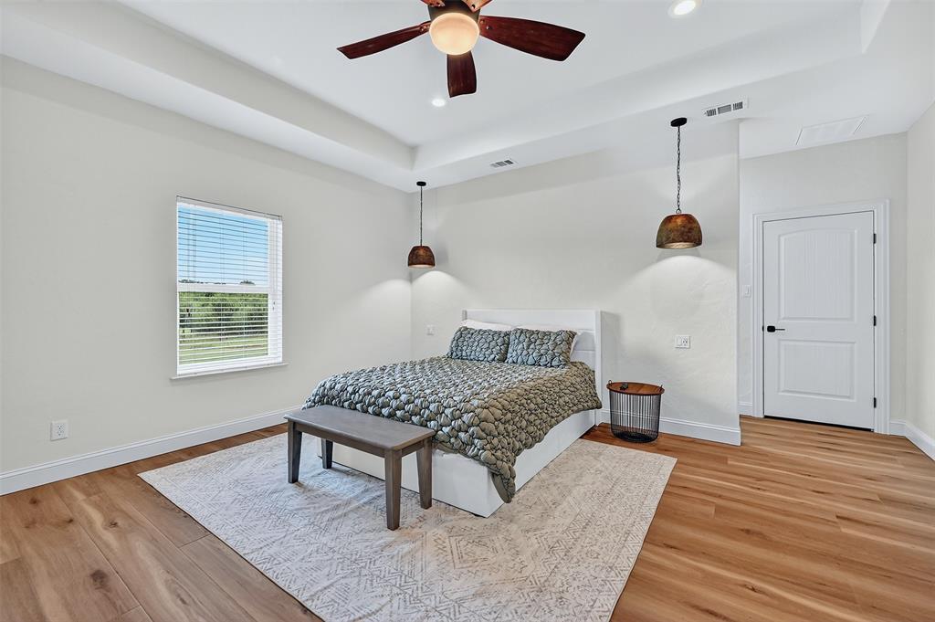 2340 Wright Road Sherman, TX 75092 - Photo 17 of 40 a bedroom with a bed and a chandelier