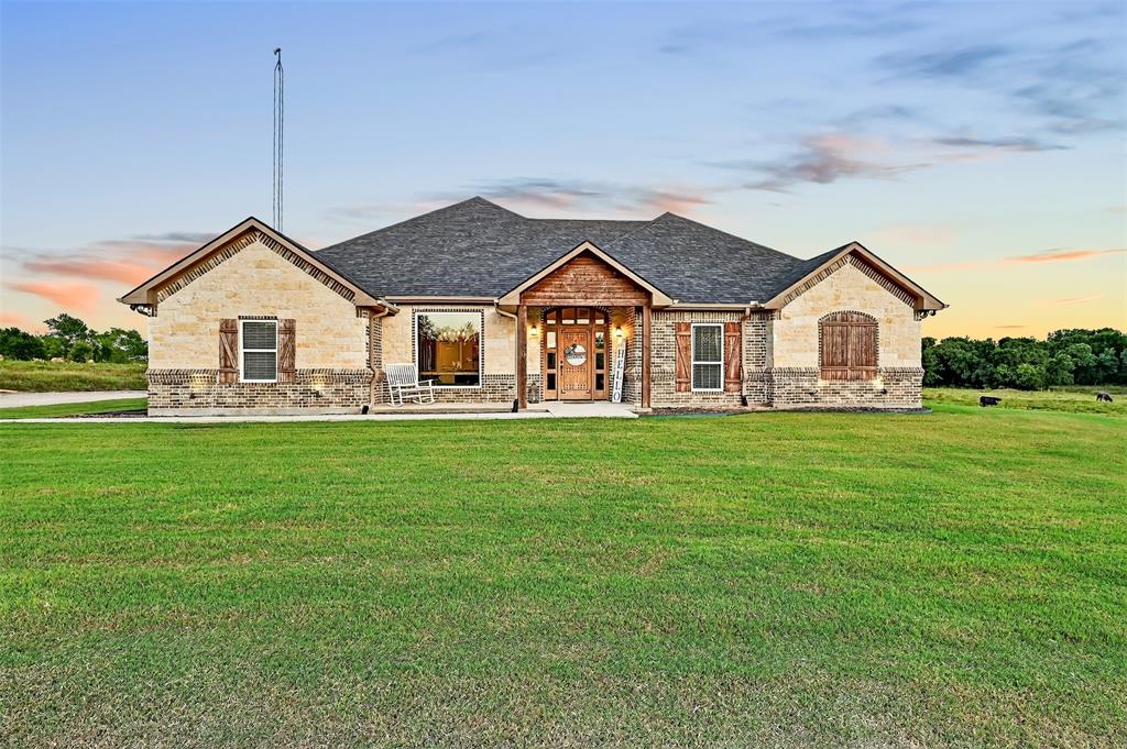 2340 Wright Road Sherman, TX 75092 - Photo 5 of 40 a front view of a house with a garden and yard