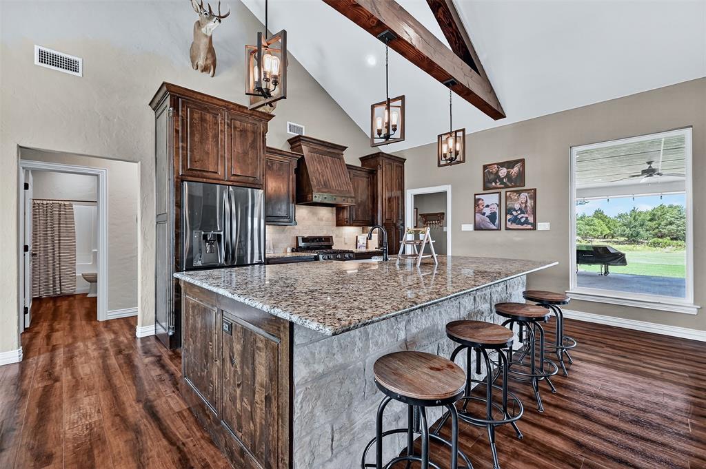2340 Wright Road Sherman, TX 75092 - Photo 10 of 40 a kitchen with stainless steel appliances granite countertop a table chairs and a refrigerator