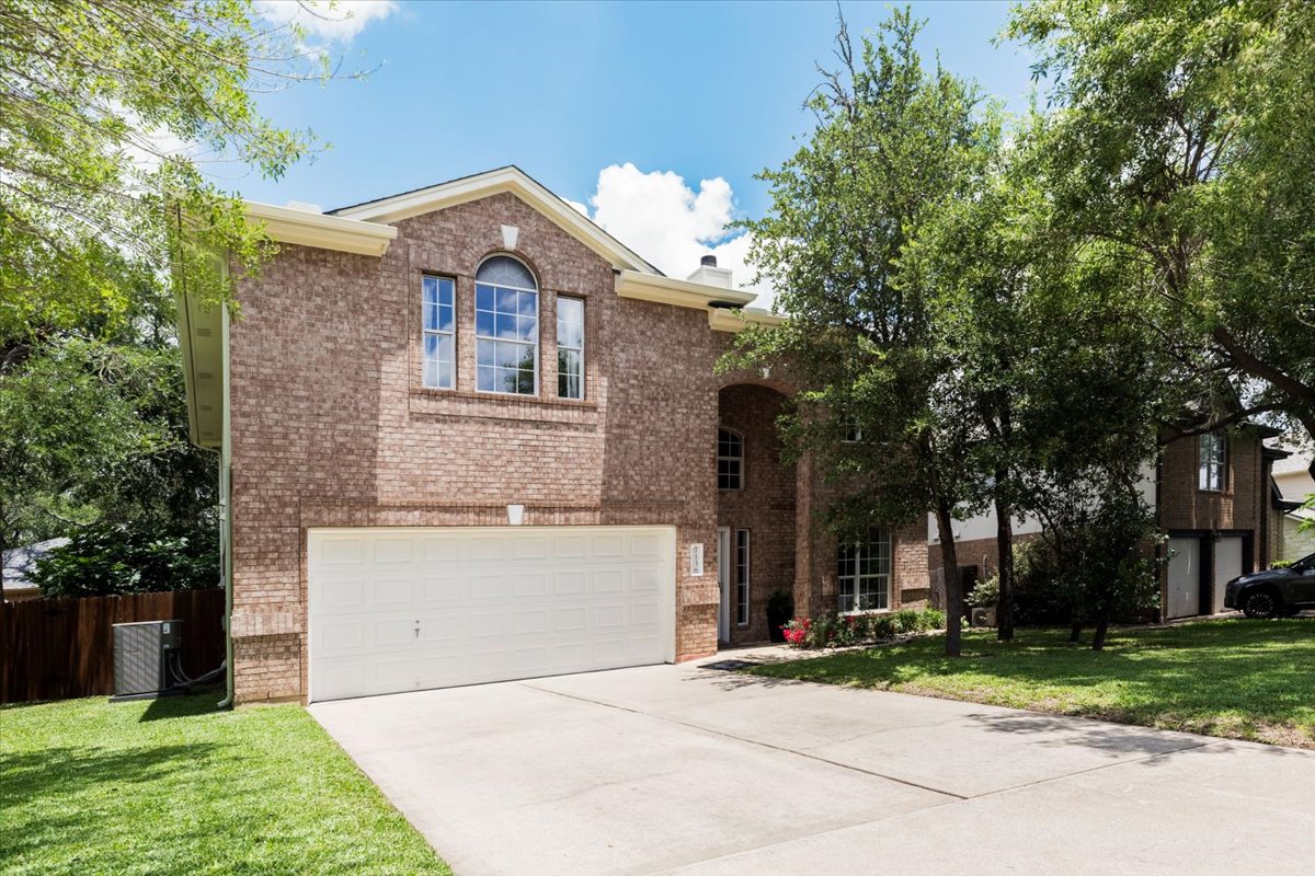 7136 Ridge Oak Road Austin, TX 78749 - Photo 2 of 28 A spacious brick residence with an integrated garage and manicured lawn welcomes you home.