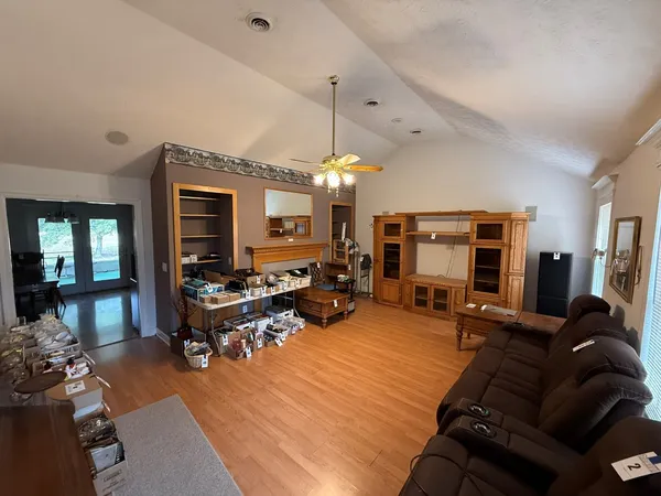 a living room with furniture a fireplace and a chandelier