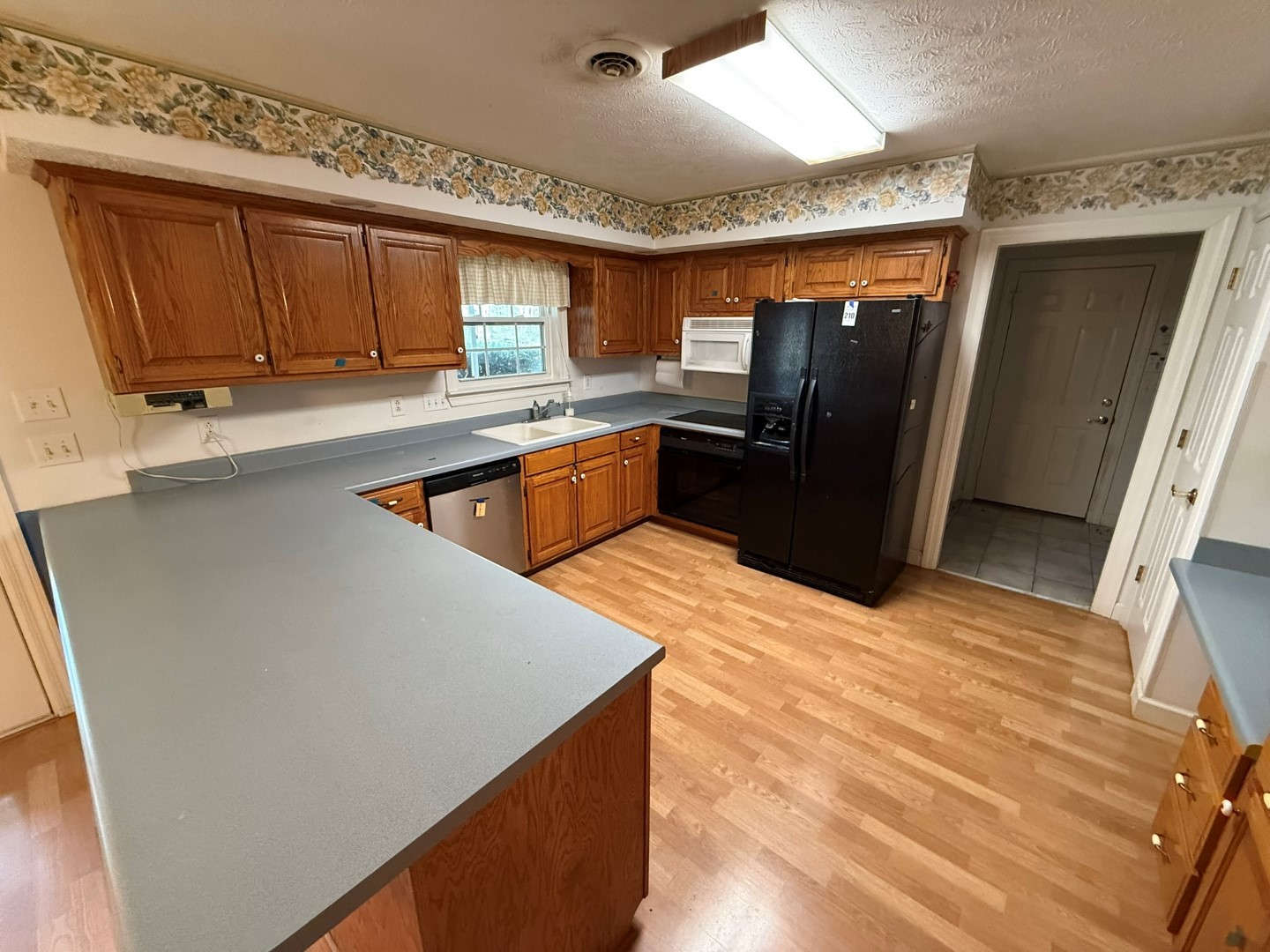 4197 Betty Ford Road Murfreesboro, TN 37130 - Photo 14 of 27 a kitchen with stainless steel appliances kitchen island granite countertop a refrigerator a sink and dishwasher