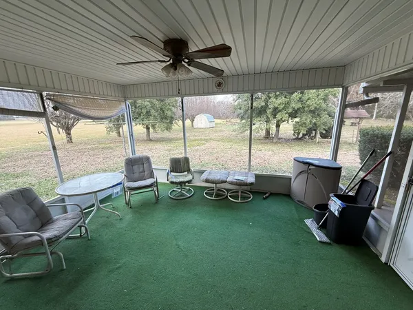 a view of a patio with chairs and a table
