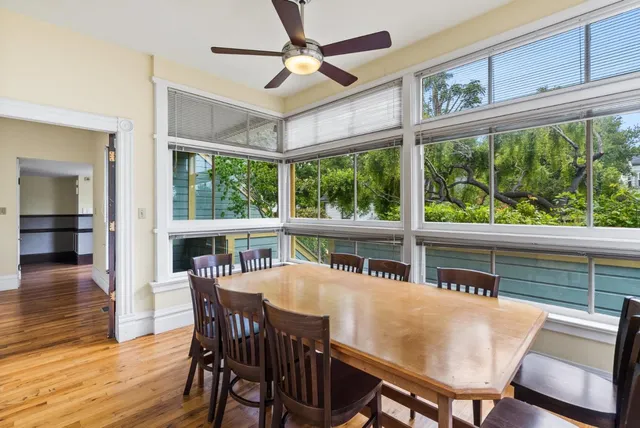 a view of a living room with furniture and floor to ceiling window