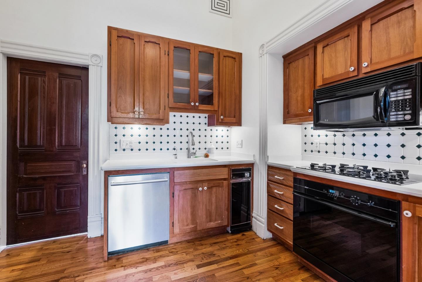 603 Mission Street Santa Cruz, CA 95060 - Photo 30 of 77 a kitchen with stainless steel appliances granite countertop a stove and a microwave oven