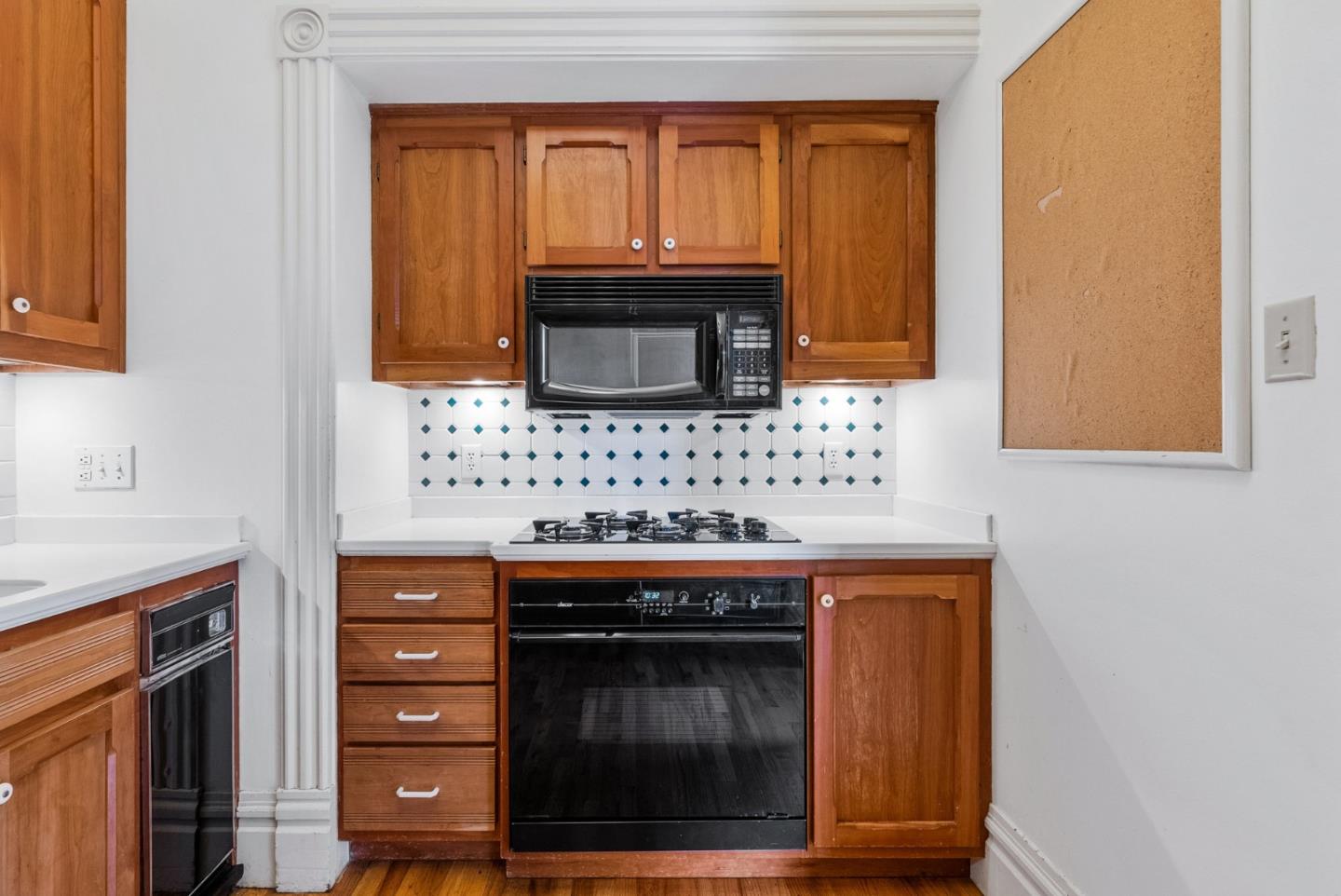 603 Mission Street Santa Cruz, CA 95060 - Photo 31 of 77 a kitchen with granite countertop a stove and a microwave
