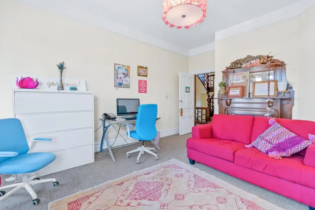 a living room with a couch and a stove top oven