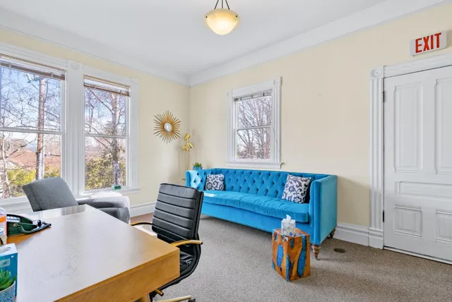 a view of a room with furniture and windows