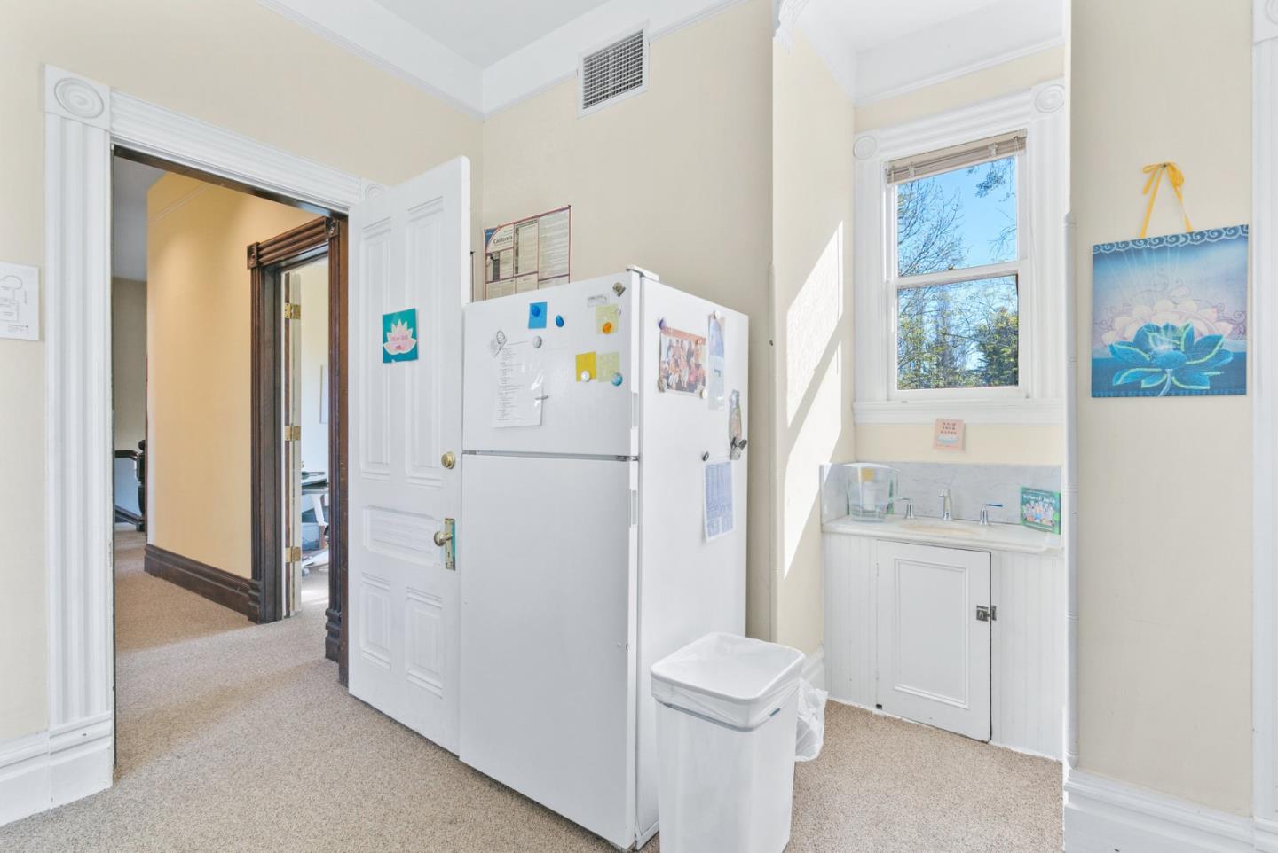 603 Mission Street Santa Cruz, CA 95060 - Photo 44 of 77 a white refrigerator freezer sitting inside of a kitchen