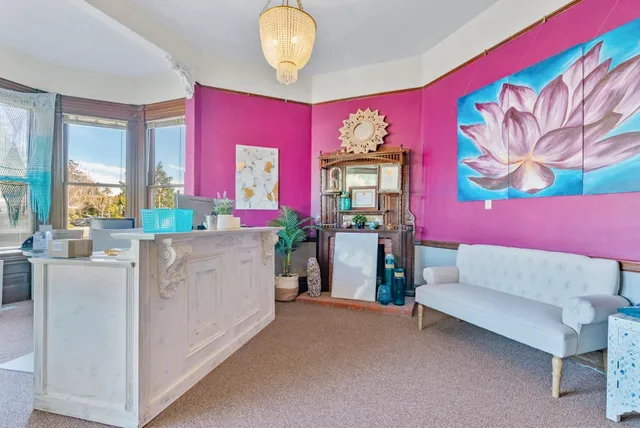 a living room with furniture and a floor to ceiling windows