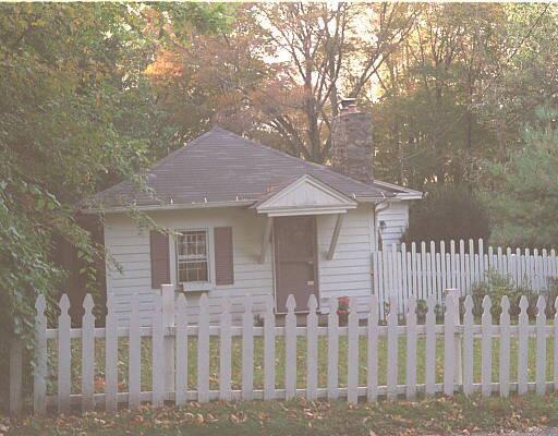 a front view of a house with wooden fence