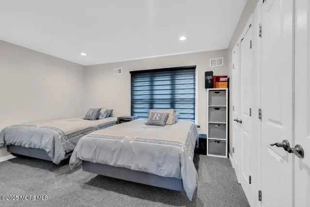 a bedroom with two beds and a closet