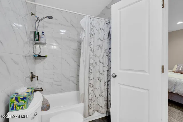 a bathroom with a bathtub and shower