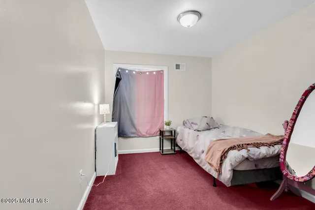 a bed room with a bed and a chair