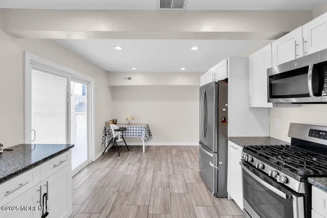 a kitchen with granite countertop a stove and a sink
