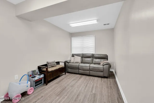 a living room with furniture window and wooden floor