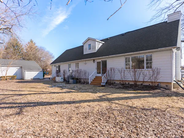 a view of a house with a yard covered in snow