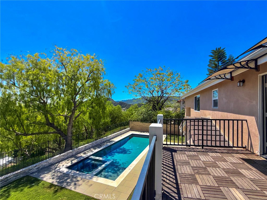 25714 Wallace Place Stevenson Ranch, CA 91381 - Photo 15 of 24 a view of a roof deck with wooden floor and fence