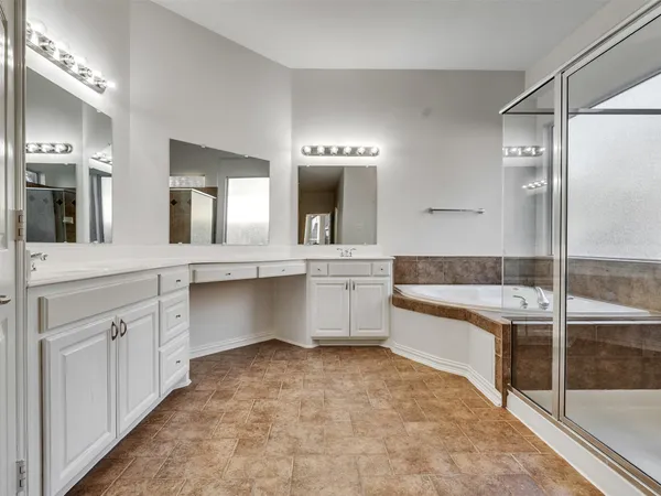 a bathroom with a granite countertop sink mirror and bathtub