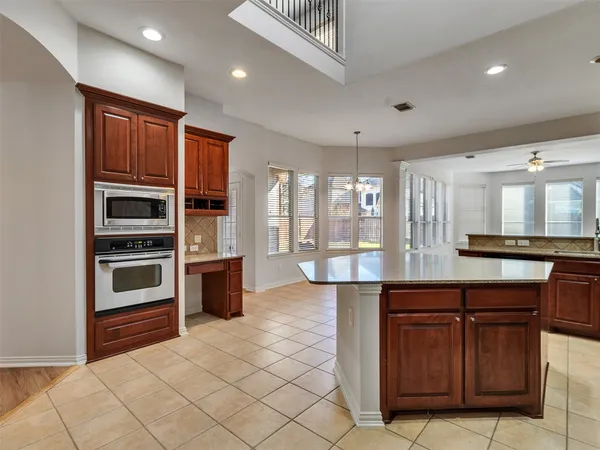 a kitchen with stainless steel appliances granite countertop a stove and a sink