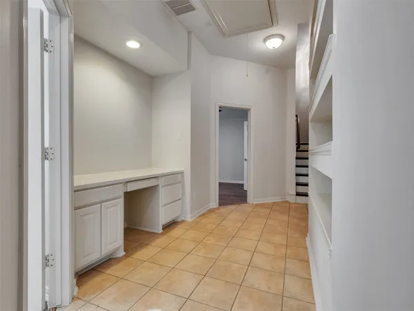 a view of a hallway with closet and bathroom