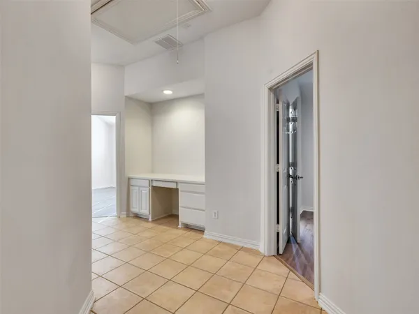 a view of an empty room and fire place