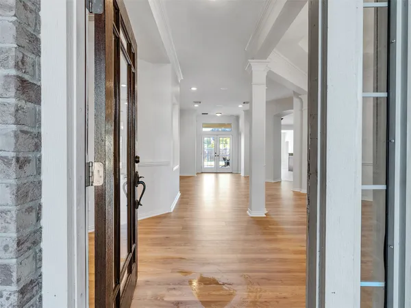 a view of a hallway with wooden floor