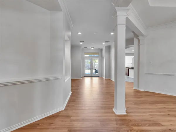 a view of a hallway with wooden floor