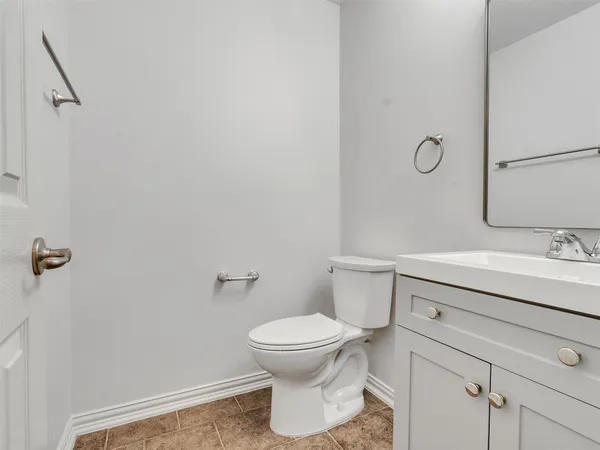 a bathroom with a sink toilet and a mirror