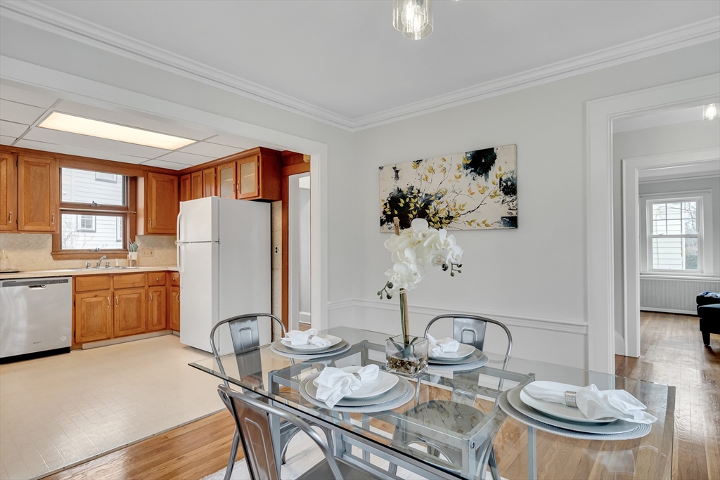 32 Valentine Road Arlington, MA 02476 - Photo 14 of 38 a view of a dining room with furniture a kitchen and chandelier