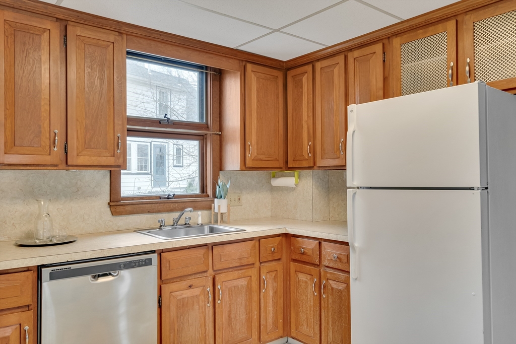 32 Valentine Road Arlington, MA 02476 - Photo 18 of 38 a kitchen with stainless steel appliances a refrigerator sink and cabinets