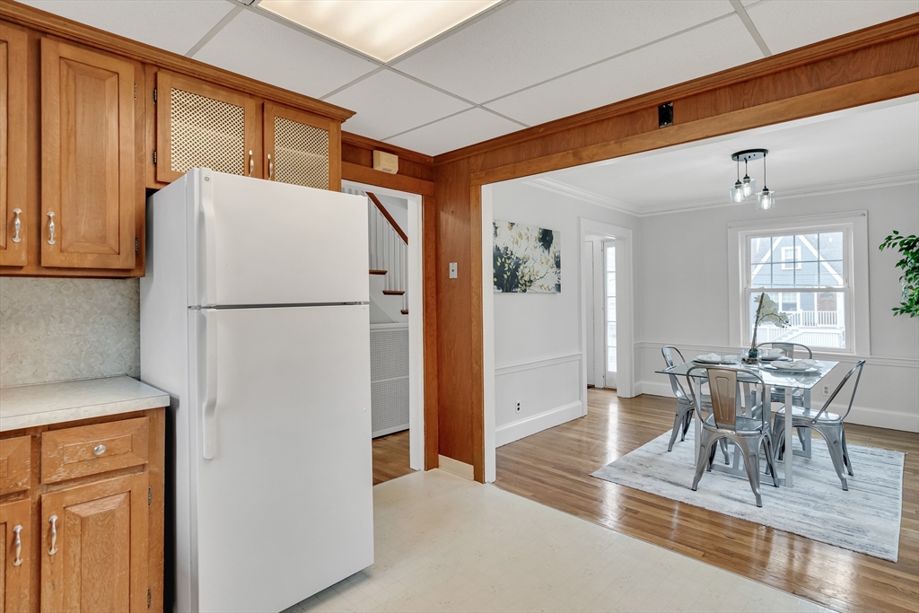 32 Valentine Road Arlington, MA 02476 - Photo 19 of 38 a kitchen with a refrigerator a table and chairs