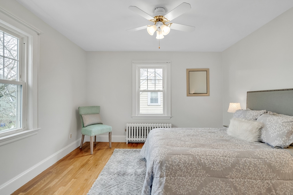 32 Valentine Road Arlington, MA 02476 - Photo 21 of 38 a bedroom with a bed a chair and a window