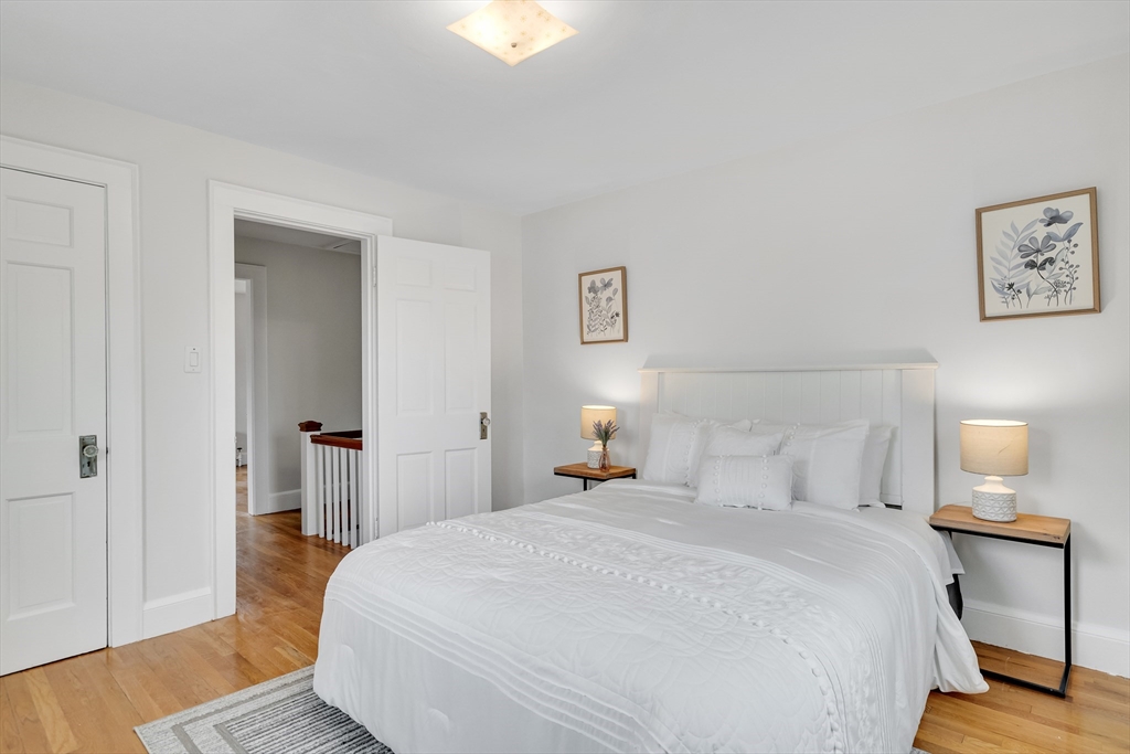 32 Valentine Road Arlington, MA 02476 - Photo 29 of 38 a bedroom with a bed and wooden floor