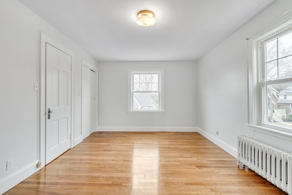 32 Valentine Road Arlington, MA 02476 - Photo 30 of 38 wooden floor in an empty room with a window