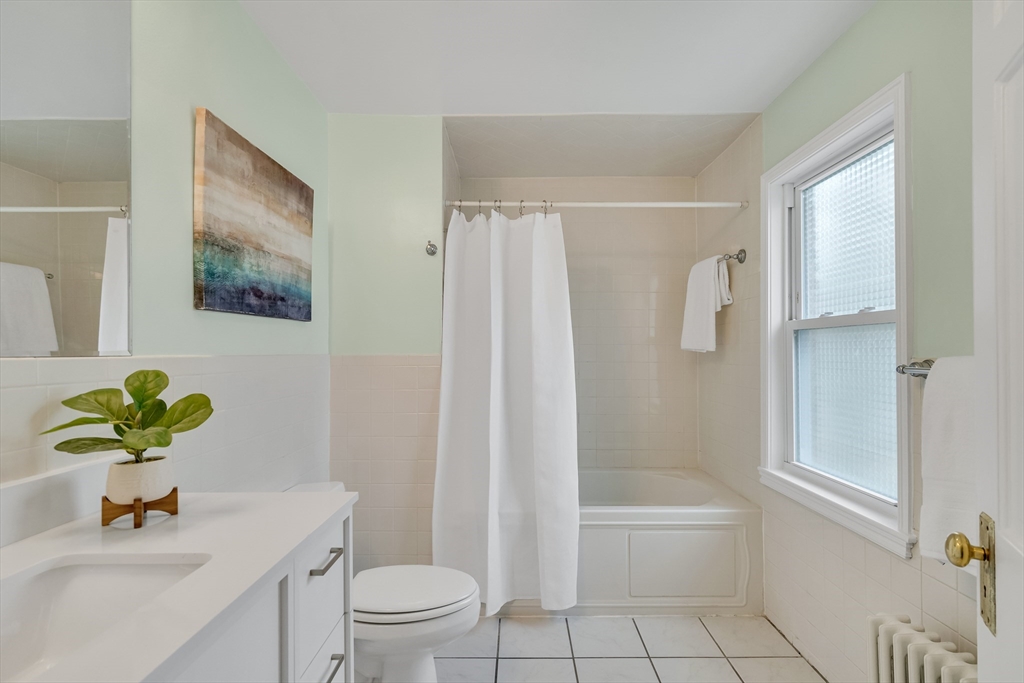 32 Valentine Road Arlington, MA 02476 - Photo 31 of 38 a bathroom with a shower sink vanity mirror and toilet