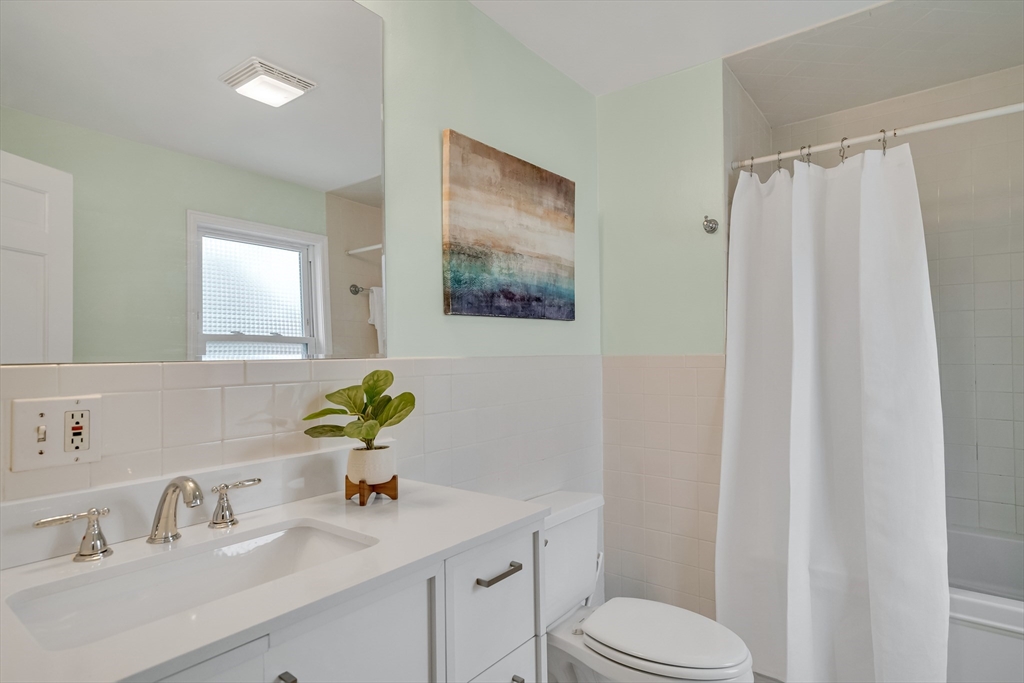 32 Valentine Road Arlington, MA 02476 - Photo 32 of 38 a bathroom with a sink mirror vanity and toilet