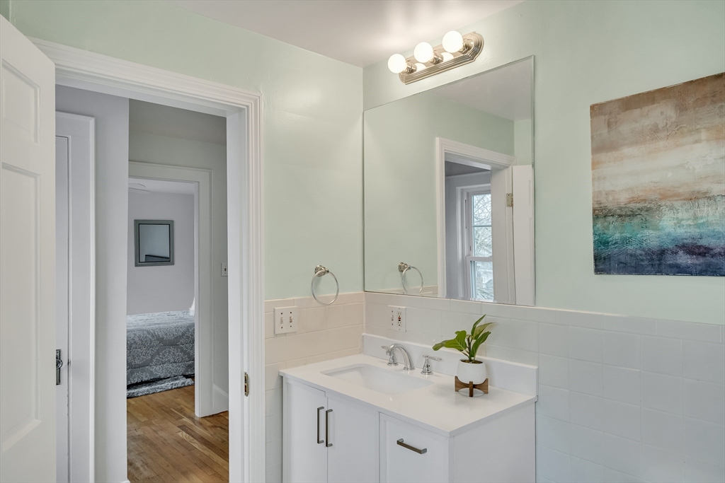 32 Valentine Road Arlington, MA 02476 - Photo 33 of 38 a bathroom with a sink vanity and a mirror