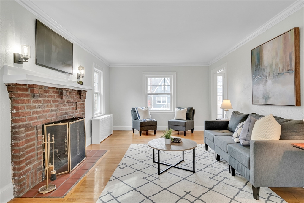 32 Valentine Road Arlington, MA 02476 - Photo 6 of 38 a living room with furniture wooden floor and a fireplace